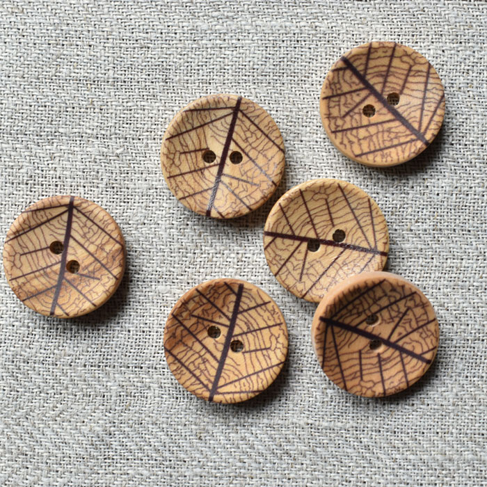 Six olive wood buttons with a laser leaf design