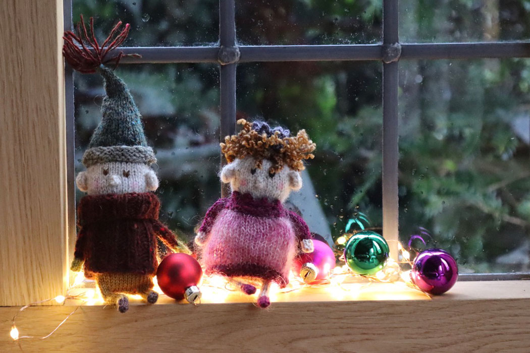 A gnome and fairy sitting on a windowsill