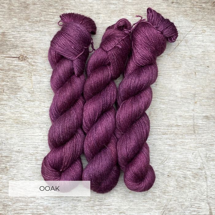 Three skeins of silky deep purple red yarn
