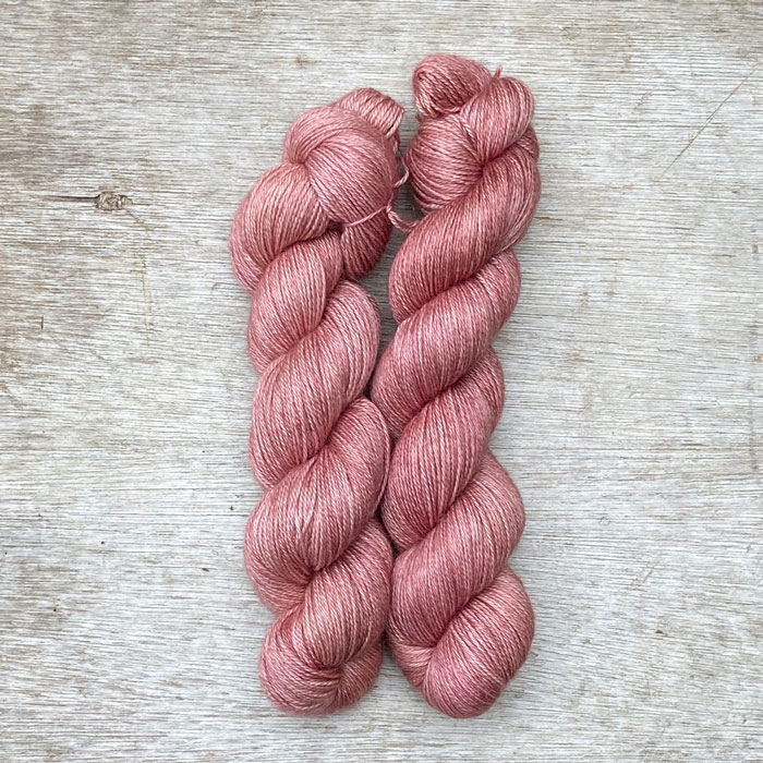 Two skeins of deep rose pink yarn