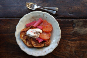 Two slices of French Toast with poached rhubarb and cream
