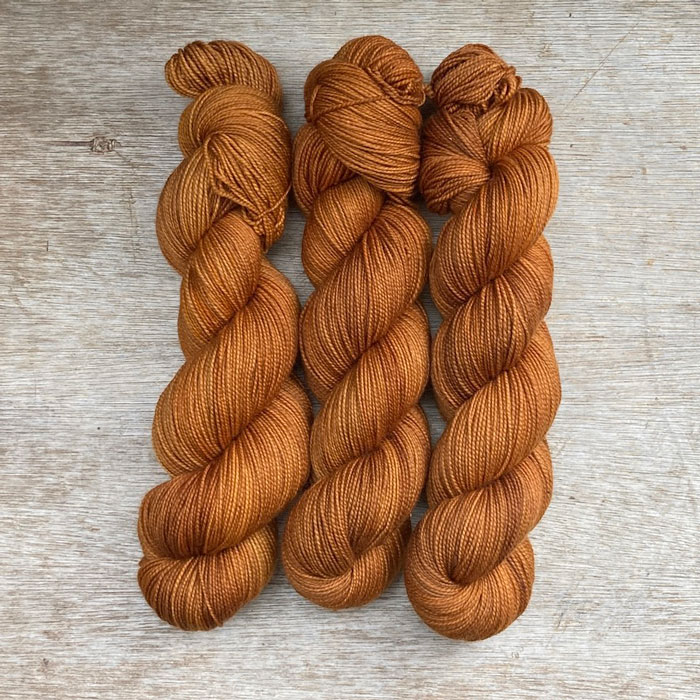 Three skeins of golden toffee coloured yarn