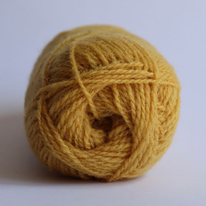 The end of a ball of wool in a old gold