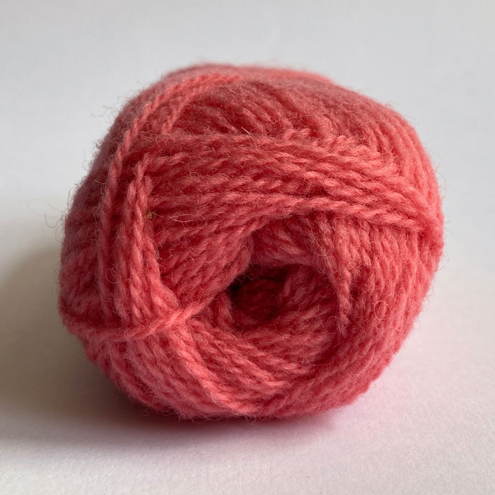 The end of a ball of wool in coral