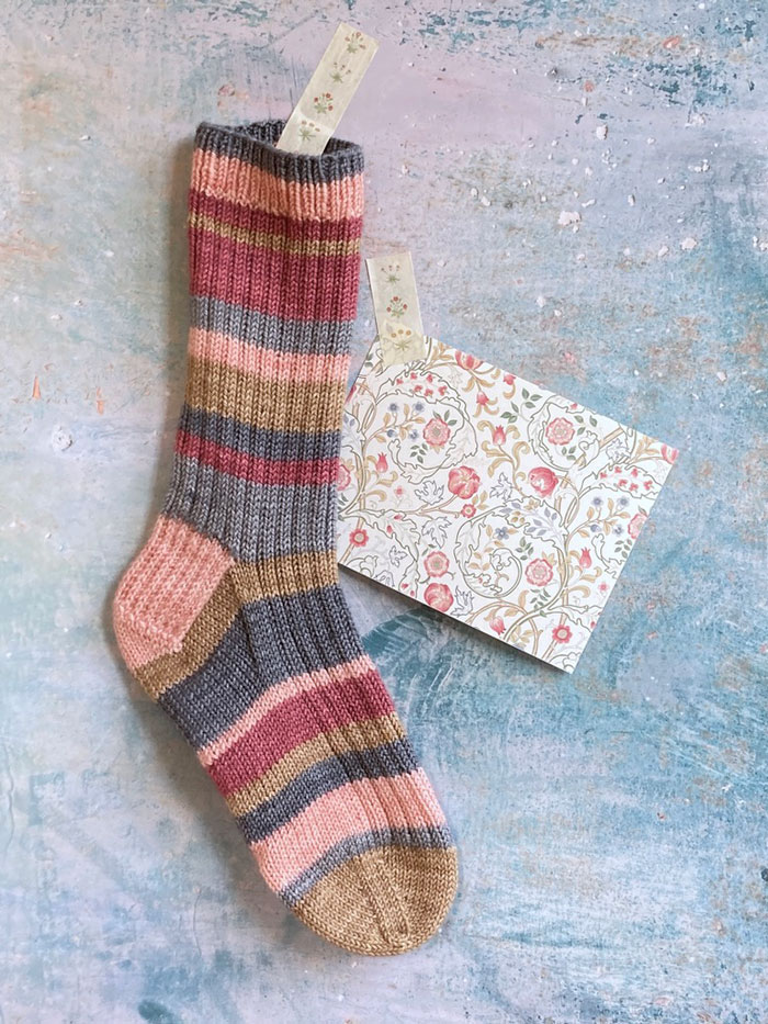 A ribbed sock knitted in random stripes