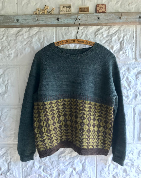 A colour work jumper in blue, mustard and brown