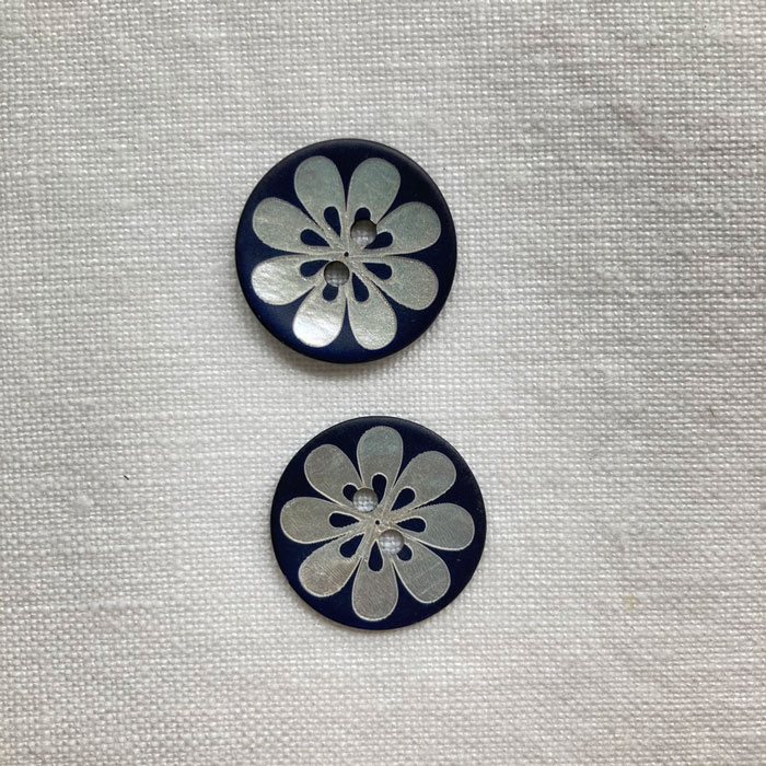 Two, matt navy shell buttons with a laser flower design, 20mm