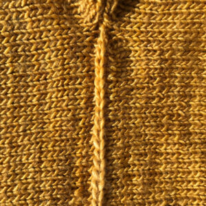 The chain edge of the modified crochet cast-off. Joining the side seam of a yellow Aeolian top