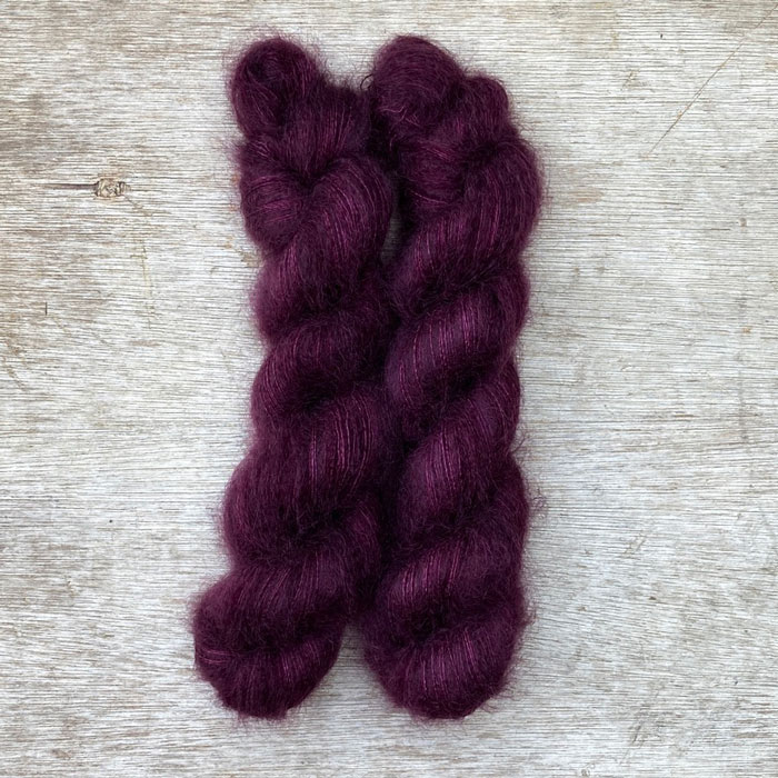 Two skeins of deep berry coloured mohair