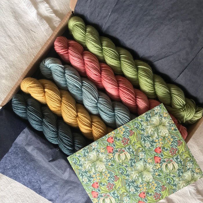 Five mini skeins in summery colours in a tissue lined box