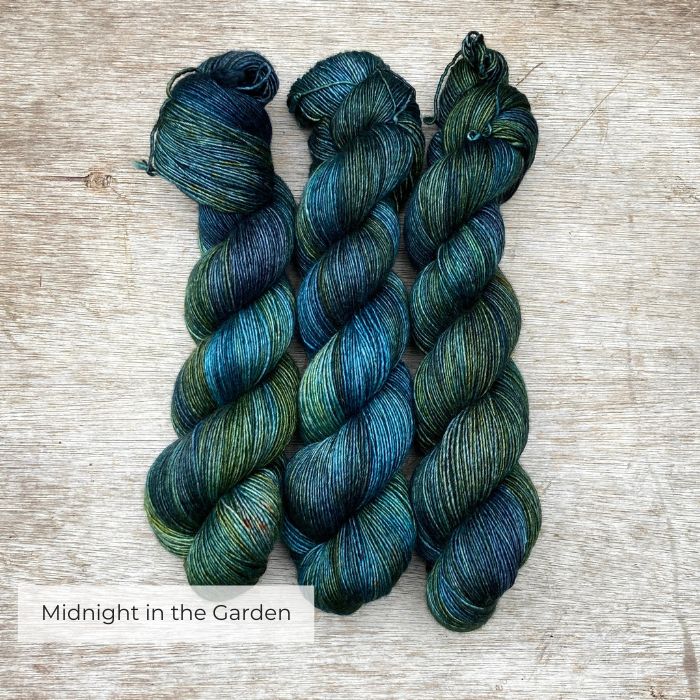 Three skeins of softly silky yarn in shades of dark blue, green and teal