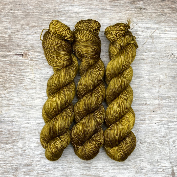 Three skeins of soft silky wool in an acid yellow green