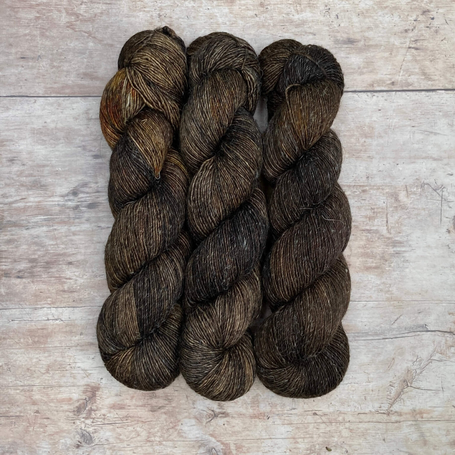 Three skeins of merino and linen in a in dark brown and grey