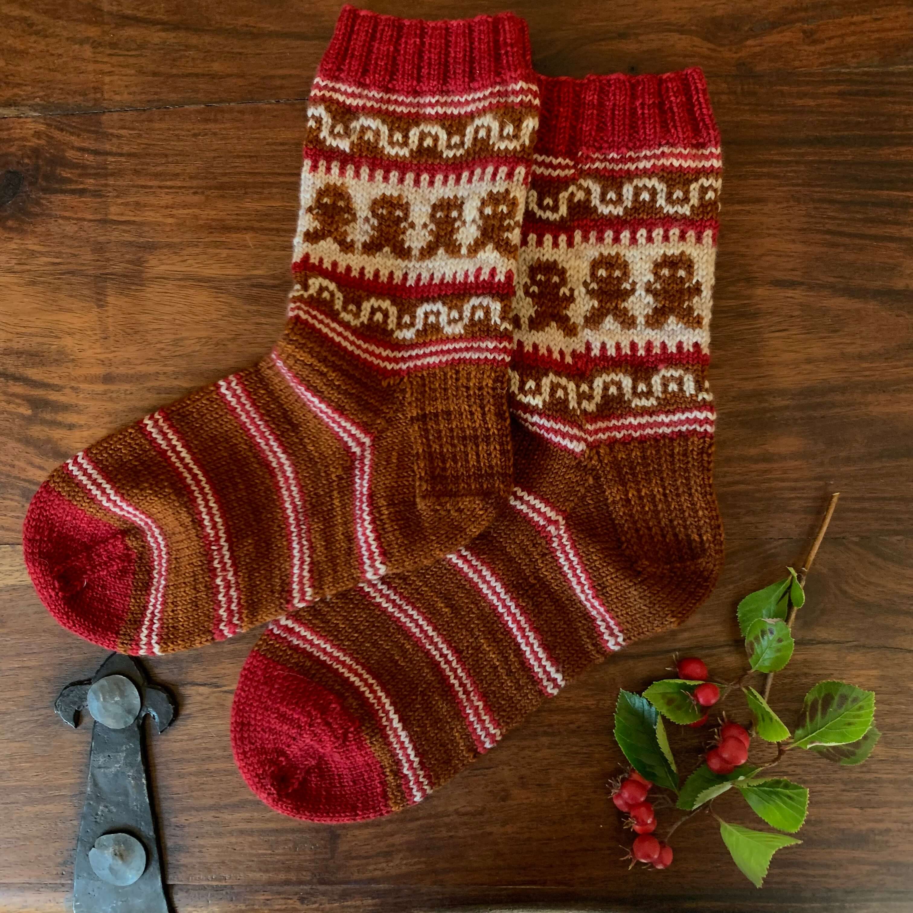 A jaunty pair of ginger socks with festive candy cane stripes and colour work gingerbread men