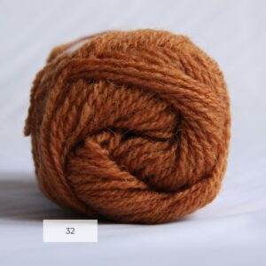 The end of a single ball of shetland wool in an amber colour