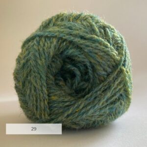 Close up of the end of a ball of wool in a soft marled green