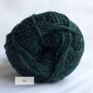 The end of a single ball of shetland wool in dark blue green colour