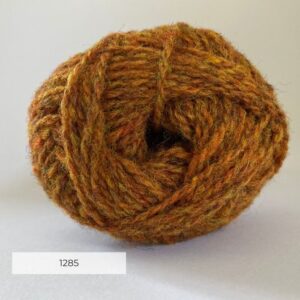 Close up of the end of a ball of wool in a light ginger