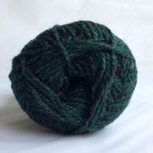 The end of a single ball of shetland wool in dark blue green colour