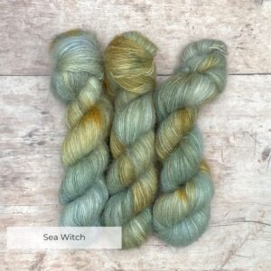 Three skeins of Mohair Lace in watery shades of blue and green with splashes of golden yellow