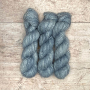 Three skeins of mohair & silk lace in a pale grey blue