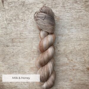 A single skein of sock wool in neutral creams and buff