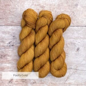 Three skeins of Classic Sock in a deep golden ochre