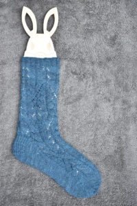 Hand knitted sock blocking on a wooden rabbit shaped sock blocker