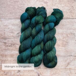 There skeins of Merino Floof in shades of dark blue, green and teal
