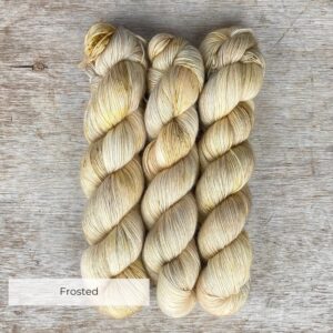 Three skeins of merino and mohair yarn in cream and cafe au lait