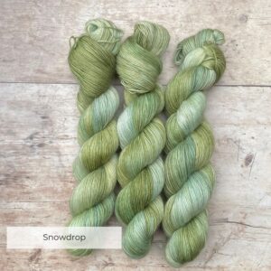 Three skeins of Merino Floof in shades of green and moss