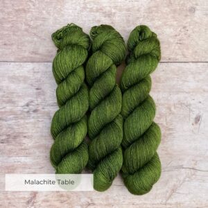 Three skeins of Merino & Silk Single in a forest green