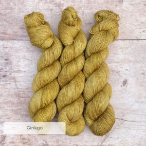 Three skeins of Merino & Silk Single in a light mustard