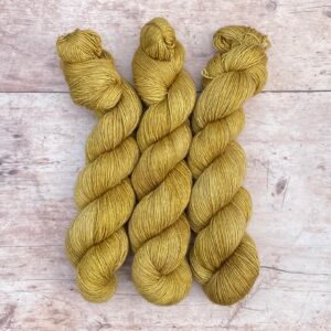 Three skeins of Merino & Silk Single in a light mustard