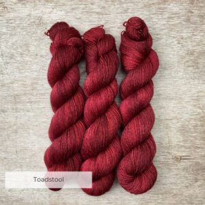 Three skeins of silky merino in a deep, dark red