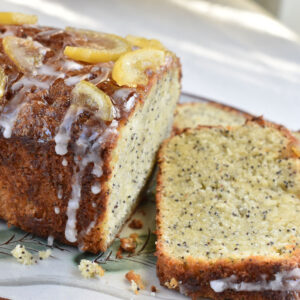 A lemon poppy seed cake with a slice taken off