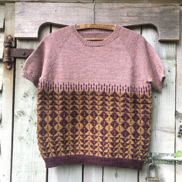 A colour work jumper on a hanger