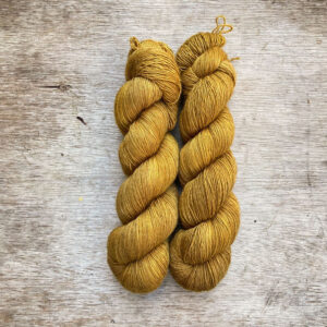 Two skeins of deep golden ochre yarn