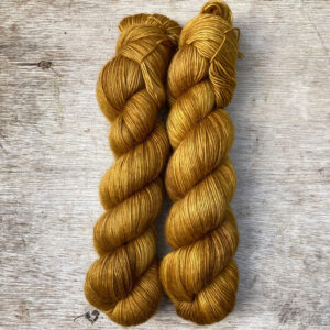 Two skeins of deep golden ochre yarn