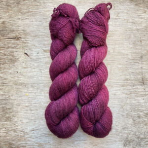 Two skeins of dark pink red wool