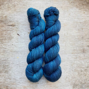 Two skeins of deep blue green