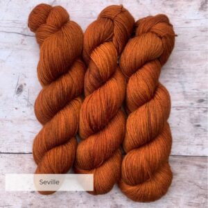 Three skeins of mohair sock in a rich orange