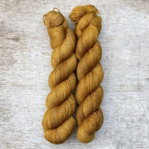 Two skeins of Classic Sock in deep golden ochre yarn