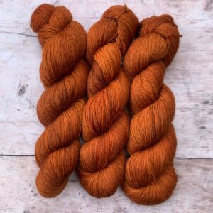 Three skeins of mohair sock in a rich orange
