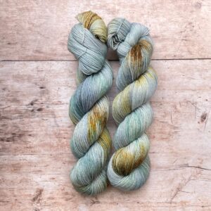 Two skeins of Mohair Sock in watery shades of blue and green with splashes of golden yellow