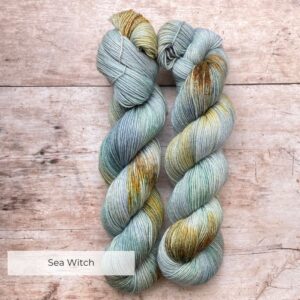 Two skeins of Mohair Sock in watery shades of blue and green with splashes of golden yellow