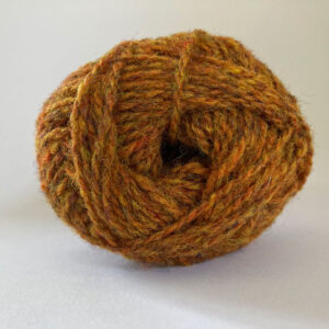 Close up of the end of a ball of wool in a light ginger