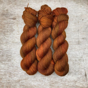 Three skeins of orange coppery yarn