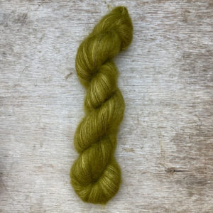 A single skein of bright olive green mohair
