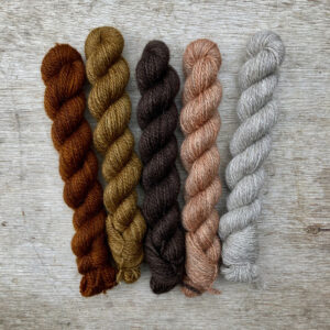 Five little mini skeins in autumnal shades of brown to coral